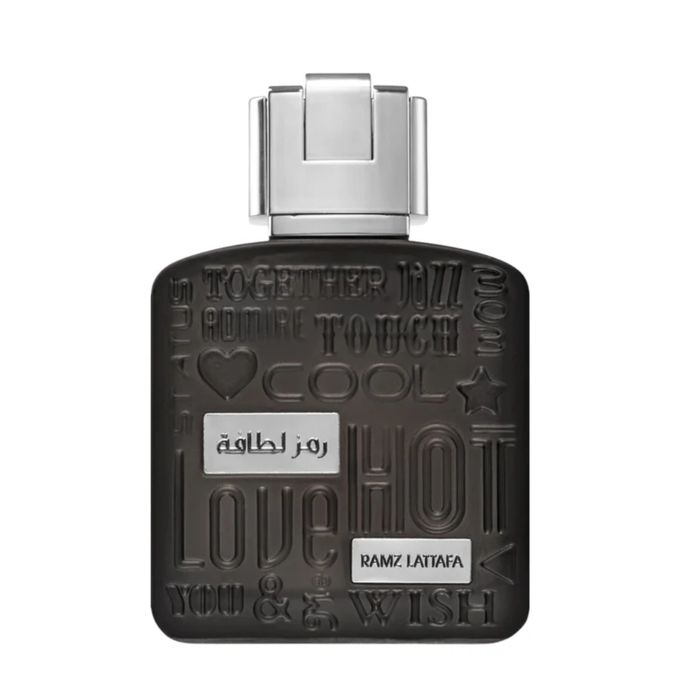 Perfume unisex Lattafa Ramz Silver Edp de 100ml, frasco elegante y moderno, con diseño en tonos plateados y detalles brillantes.